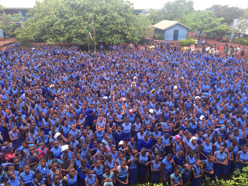 Queens School Enugu students attending morning assembly in their uniforms.