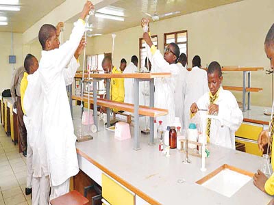 Mount Saint Gabriel’s students in uniform performing a science experiment in Makurdi laboratory.