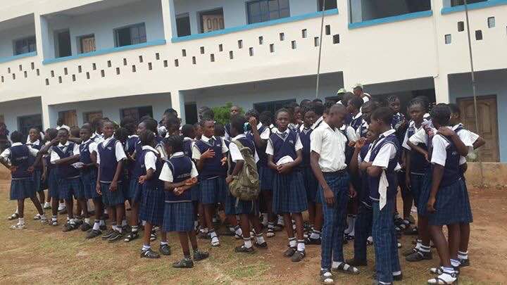 Federal Government College Idoani school building and students during assembly
