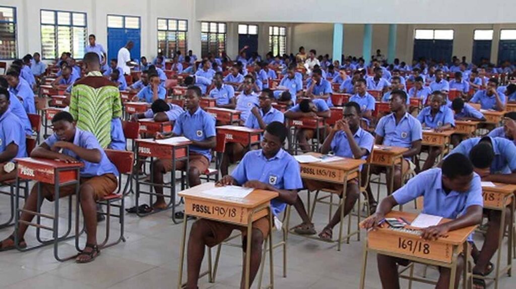 Nigerian students writing WAEC 2025 exam in classroom